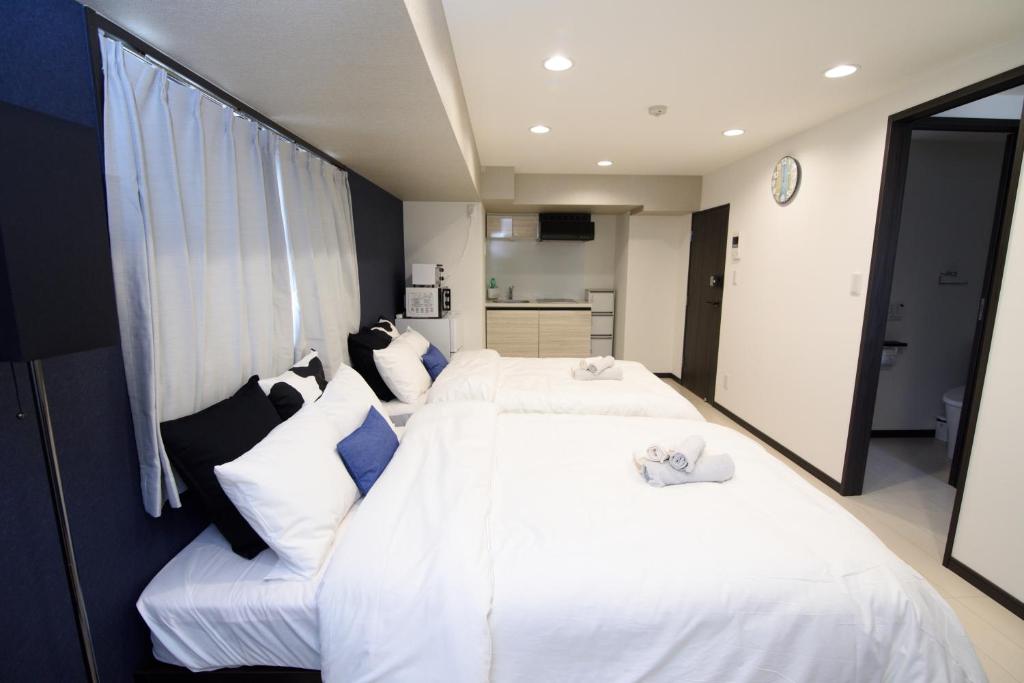 Postel nebo postele na pokoji v ubytování Hotel Central Yokohama