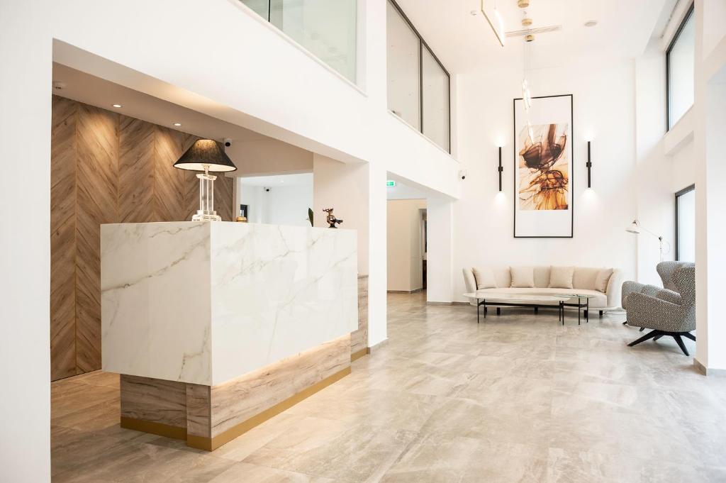a lobby with a marble counter and a couch at Roseum Boutique Hotel in Larnaka