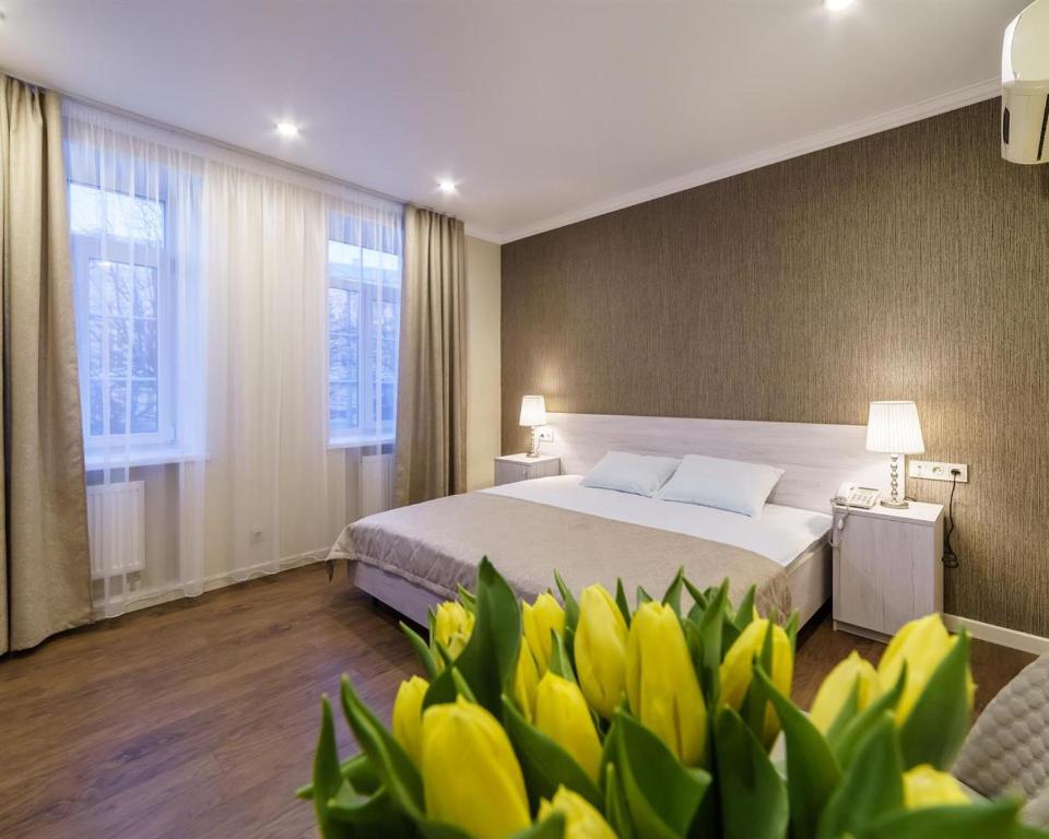トヴェリにあるROSSI HOTELのベッドルーム1室(前面に黄色い花のベッド1台付)