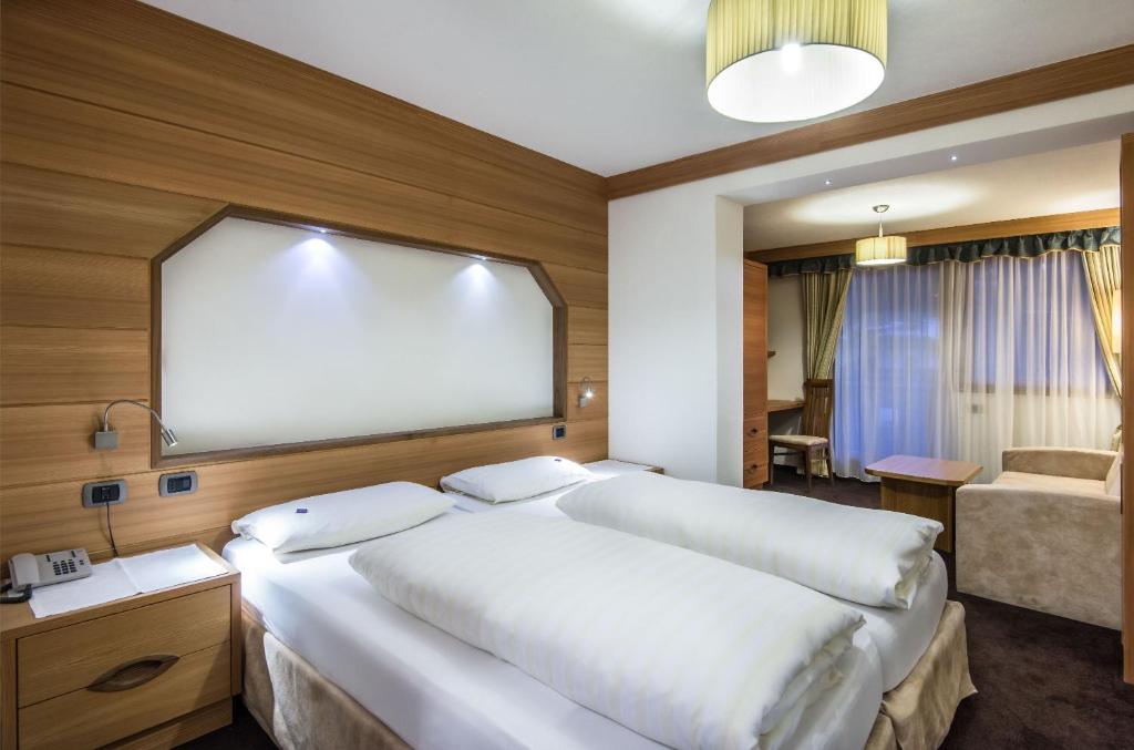 Postel nebo postele na pokoji v ubytování Albergo Posta Pederoa