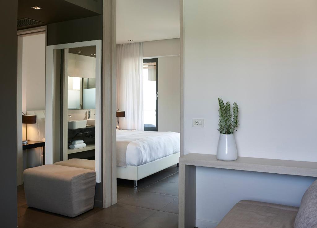A bed or beds in a room at Pelagos Suites Hotel & Spa