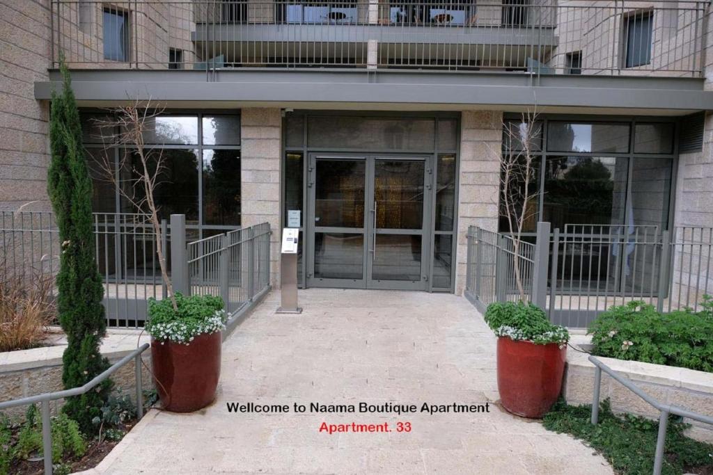 an entrance to a building with a glass door at Naama New Boutique Apartment in Jerusalem