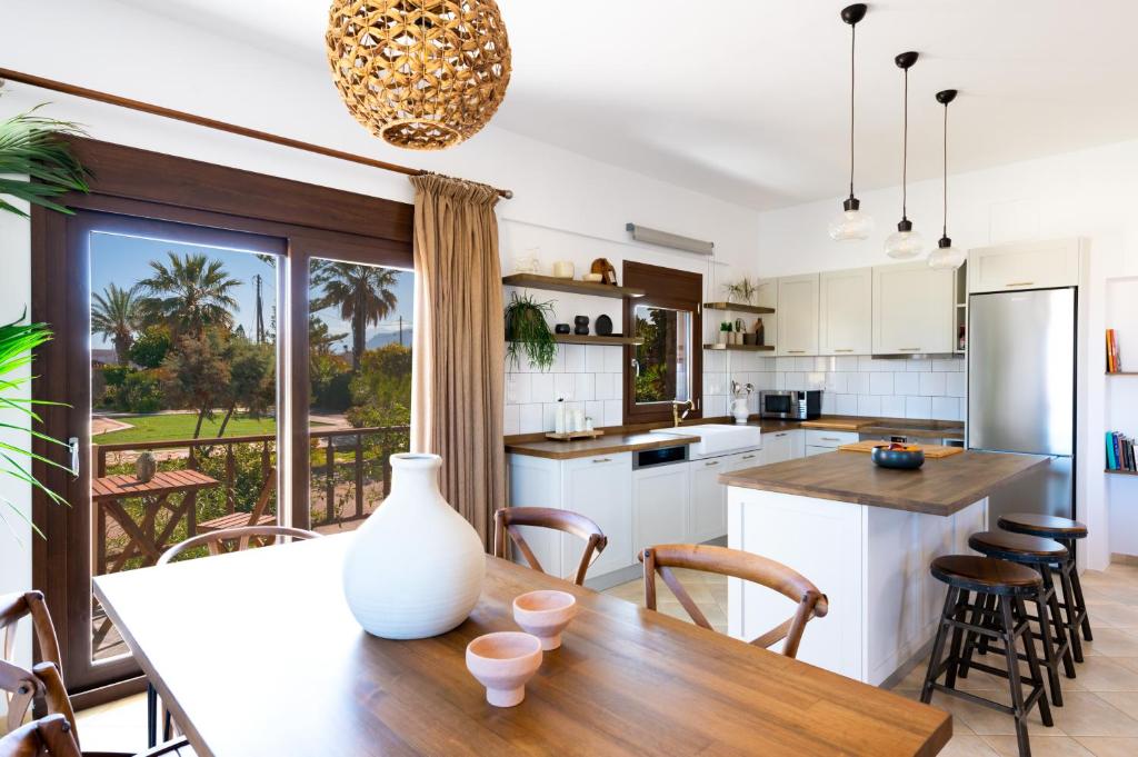 a kitchen and dining room with a table and chairs at Villa Mika in Gouves