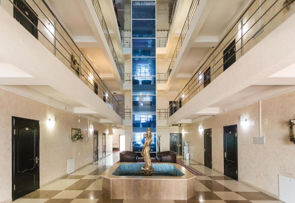 un vestíbulo con una fuente en medio de un edificio en Hotel Oasis, en Adler