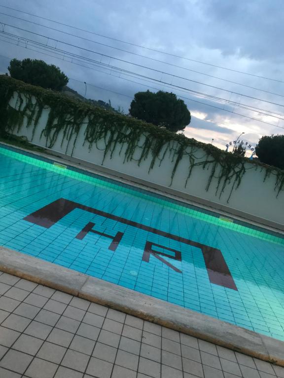 a swimming pool with blue water and plants in it at Hotel Royal in San Benedetto del Tronto