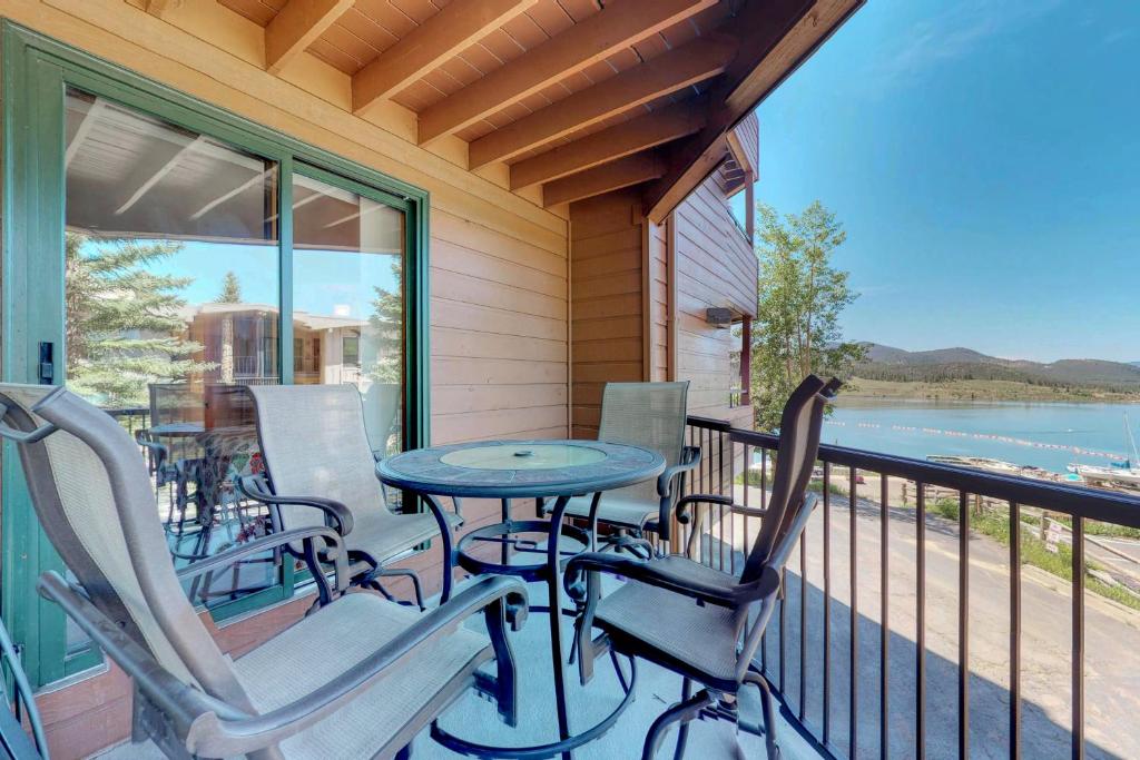 a porch with a table and chairs and a view of the water at La Bonte Leisure Beauty in Dillon