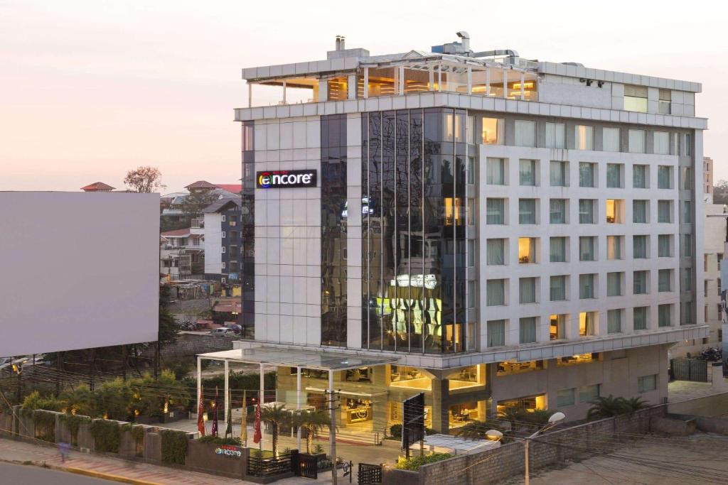 a building with a sign on the side of it at Ramada Encore Domlur Bangalore in Bangalore