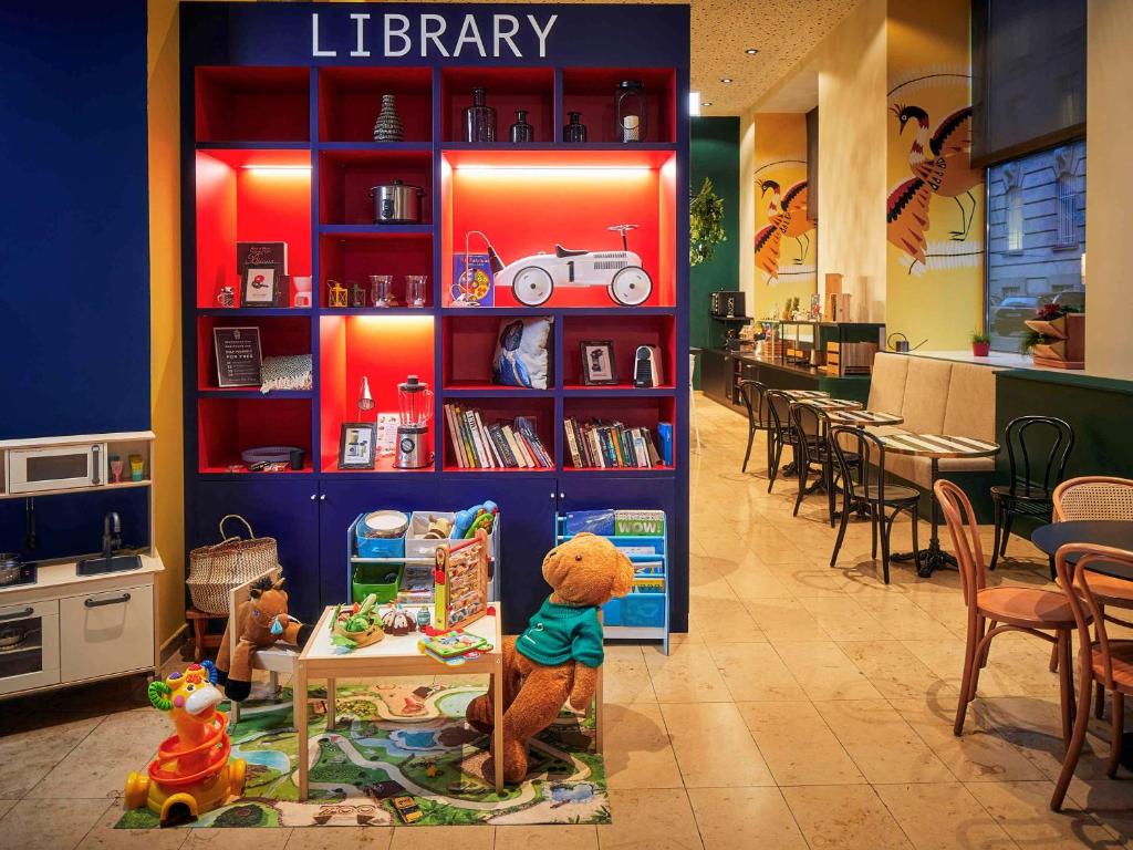 
a small children's book store with bookshelves full of books at Aparthotel Adagio Vienna City in Vienna
