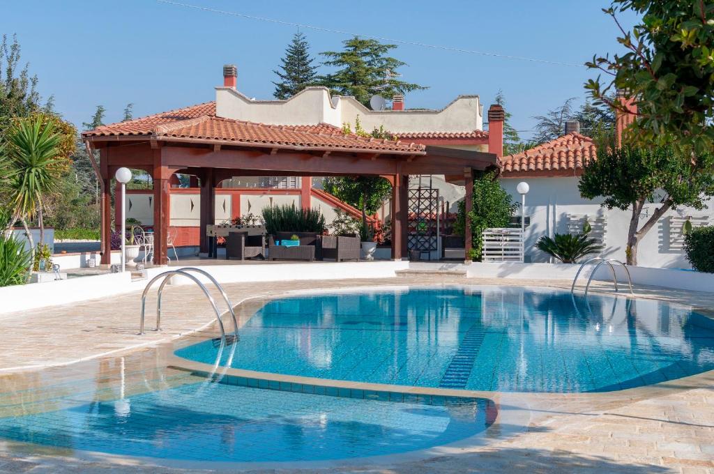 a swimming pool in front of a gazebo at Villa Nicodemo in Impalata