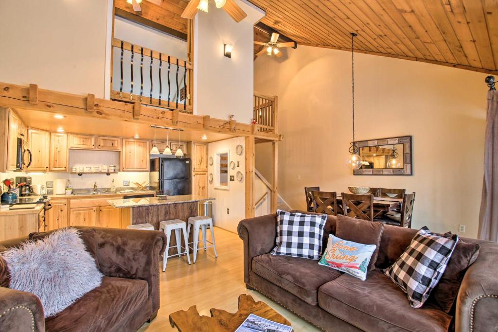 a living room with two couches and a kitchen at Updated Loon Townhome with Mtn Views and Ski Shuttle! in Lincoln