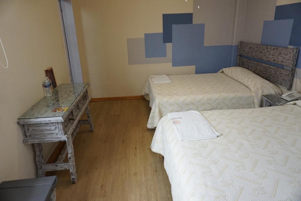 Postel nebo postele na pokoji v ubytování Hotel Palacio