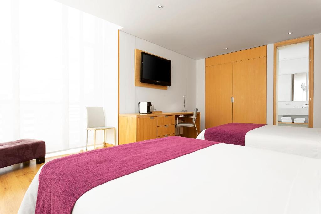 Postel nebo postele na pokoji v ubytování Hotel bh Parque 93