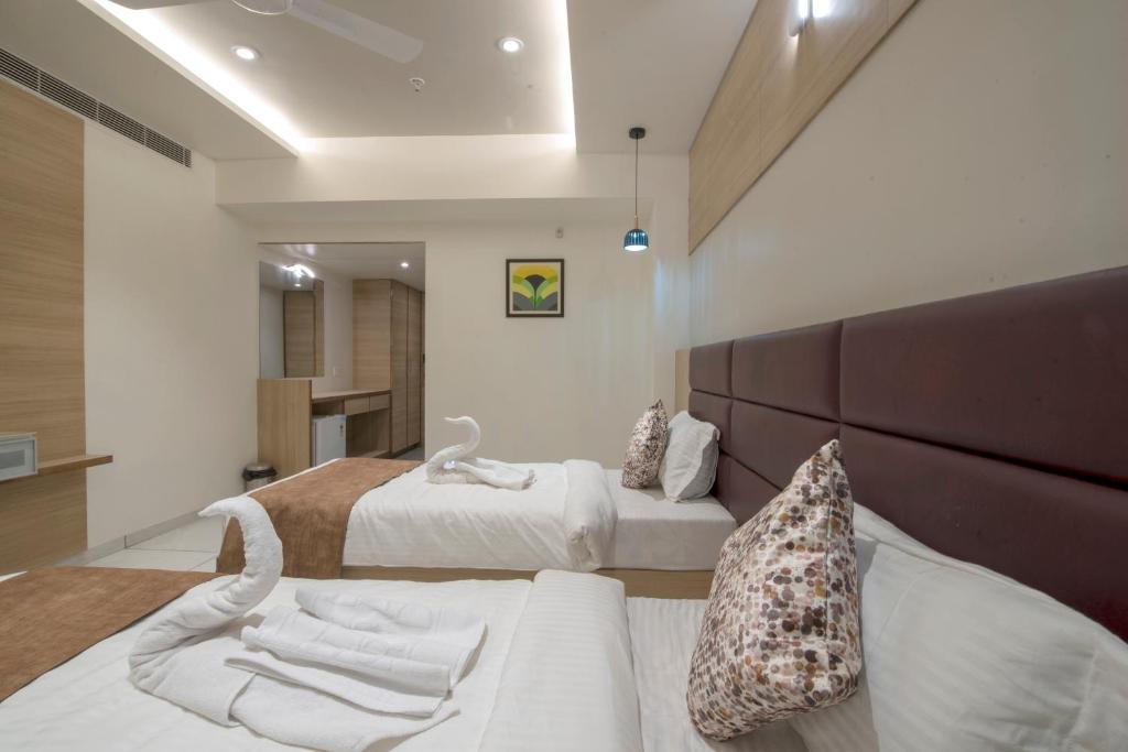 Postel nebo postele na pokoji v ubytování HOTEL SILVERA GRAND