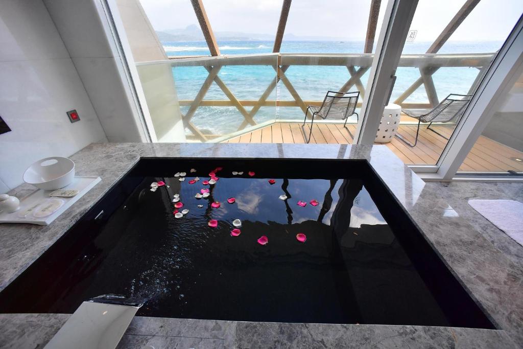 a plunge pool in the floor of a room with the ocean at Volando Kenting in Hengchun
