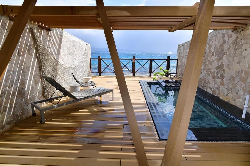 a balcony with a hammock and a swimming pool at Volando Kenting in Hengchun