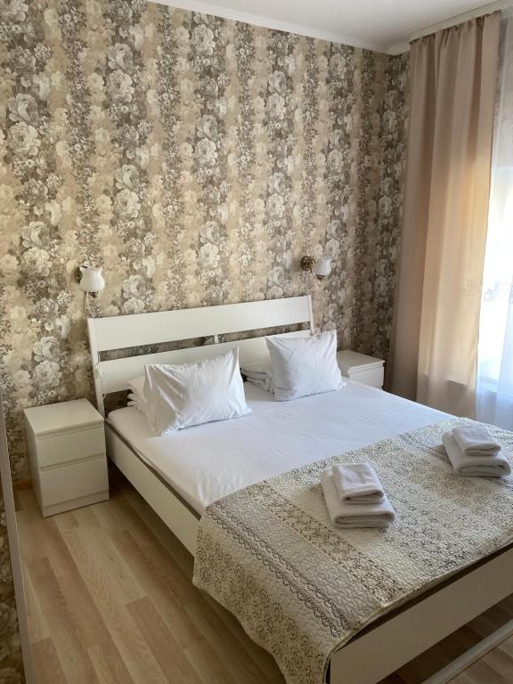 a bedroom with a bed with two towels on it at City Westa Hotel in Riga