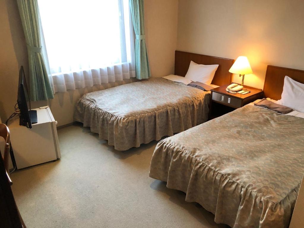 Postel nebo postele na pokoji v ubytování Sky Hotel