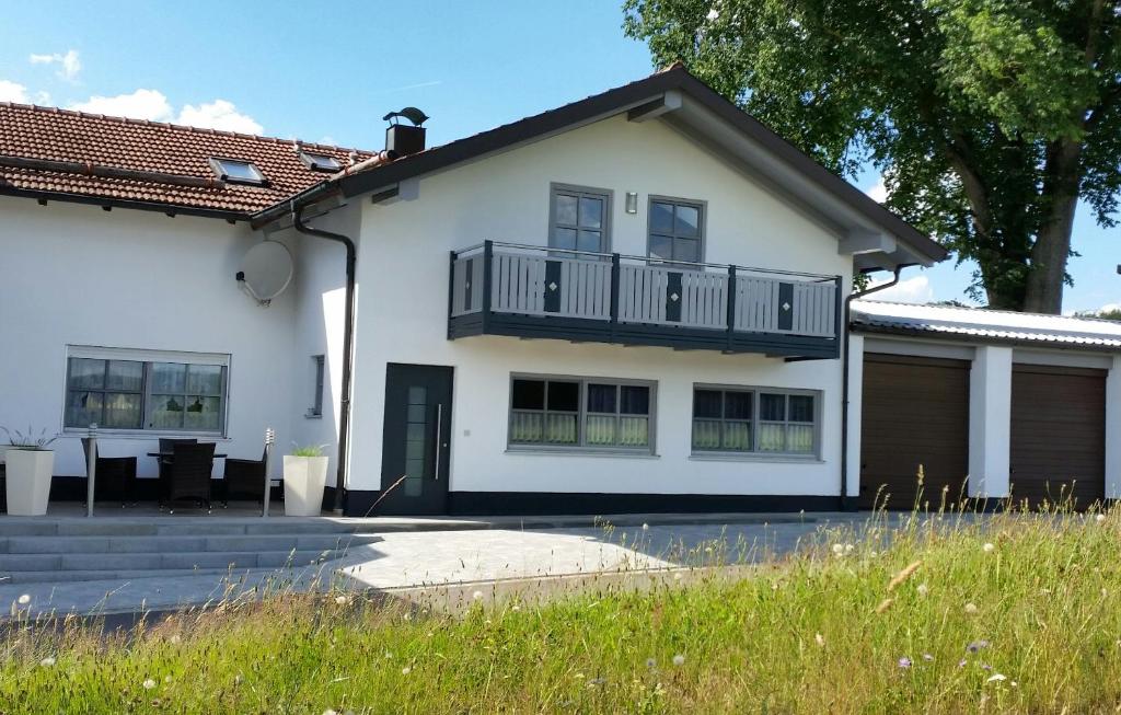 a white house with a balcony at Ferienwohnung Spachtholz in Waldmünchen