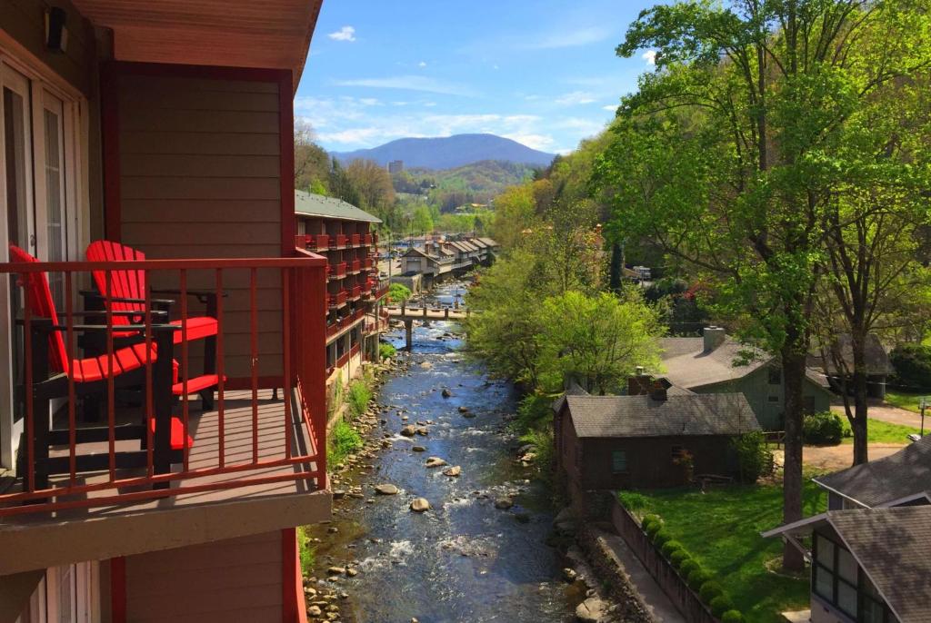 a view of a river from the balcony of a house at Baymont by Wyndham Gatlinburg On The River in Gatlinburg
