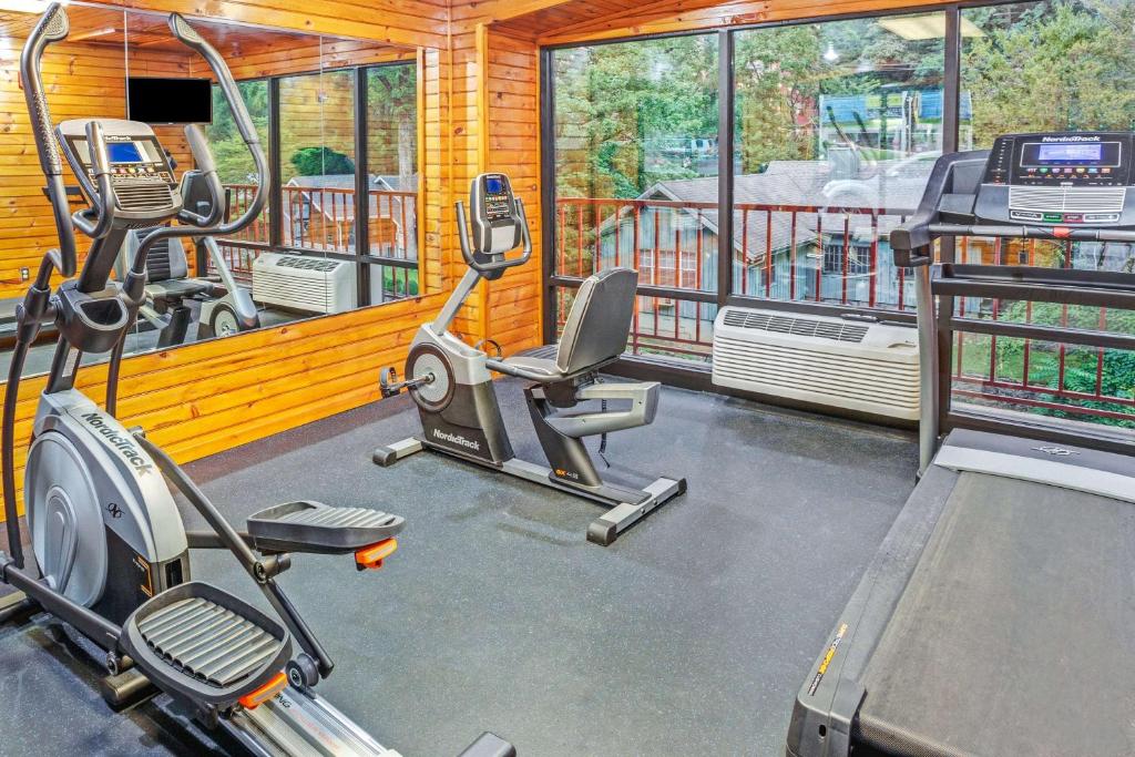 a gym with two exercise bikes and a simulator at Baymont by Wyndham Gatlinburg On The River in Gatlinburg