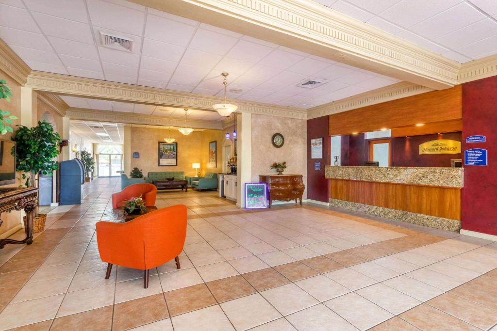 an empty lobby of a hospital with orange chairs at Howard Johnson by Wyndham Lakeland in Lakeland