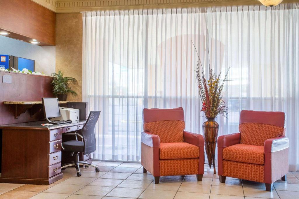 an office with two chairs and a desk and a computer at Howard Johnson by Wyndham Lakeland in Lakeland