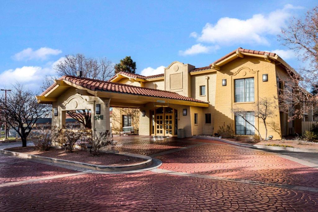 a house with a brick driveway in front of it at La Quinta Inn by Wyndham Albuquerque Northeast in Albuquerque