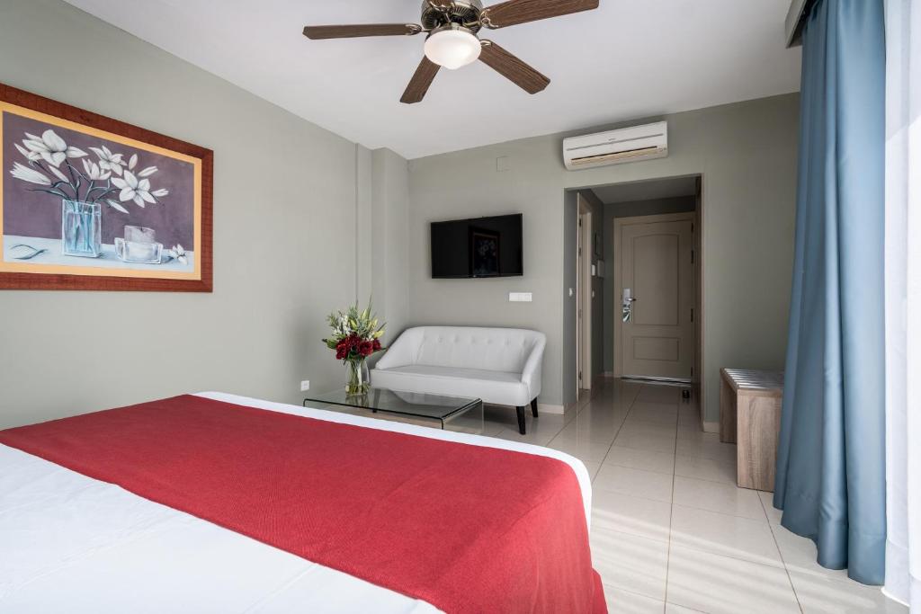 a bedroom with a bed and a ceiling fan at Los Arcos in Nerja