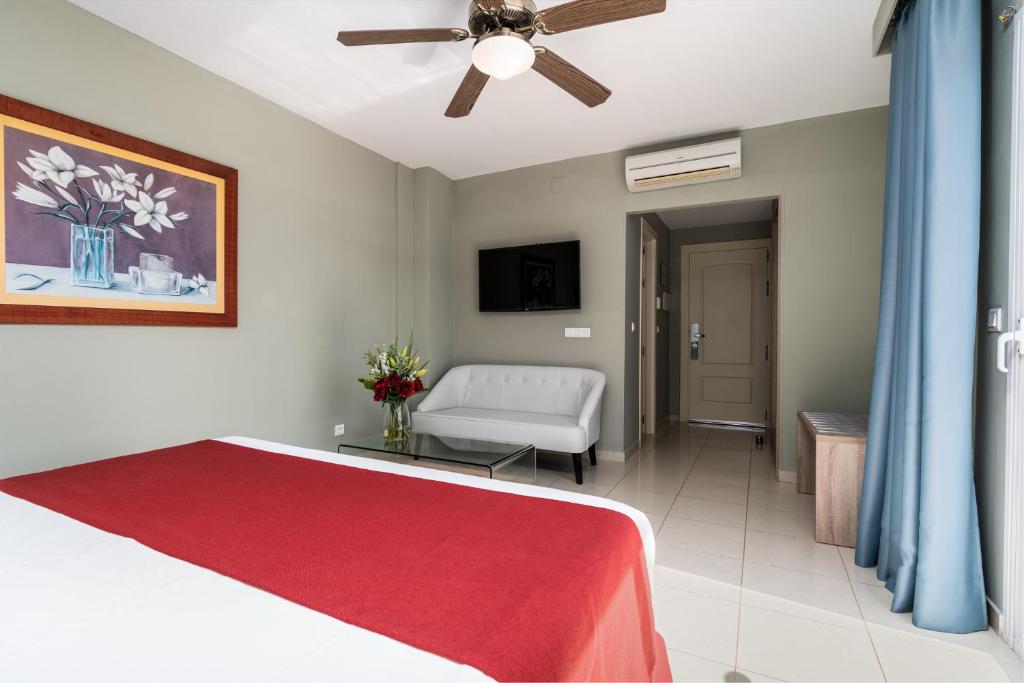a bedroom with a bed and a ceiling fan at Los Arcos in Nerja