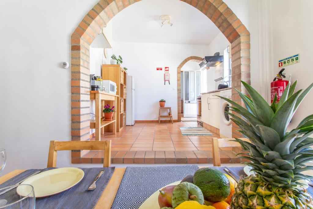 a dining room with a table with fruit on it at Casa Oceano-Ave do Mar in Raposeira