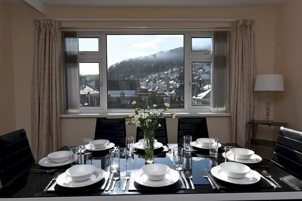 a dining room table with a view of a city at Riverside 6 in Dartmouth