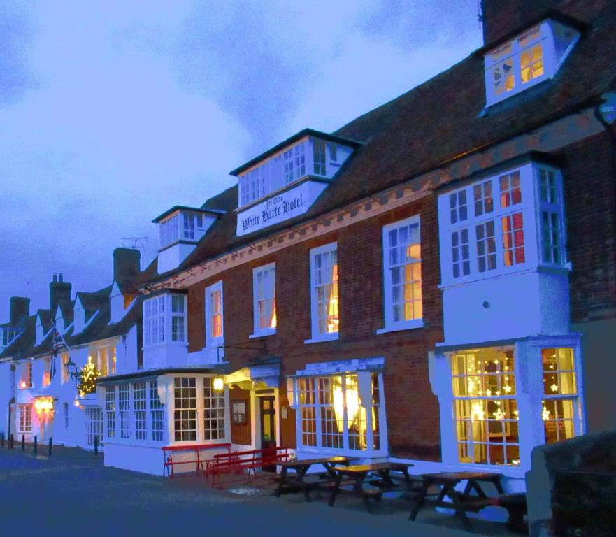 a building with tables in front of it at night at Ye Olde White Harte Hotel in Burnham-on-Crouch