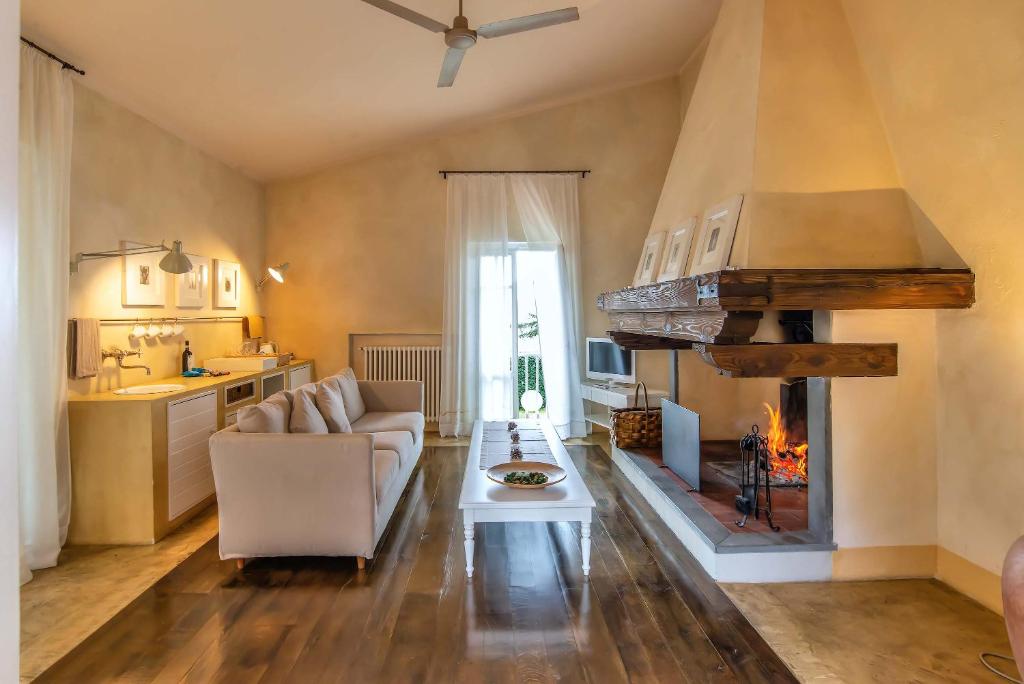 a living room with a couch and a fireplace at Villa Cassia di Baccano in San Giustino Valdarno