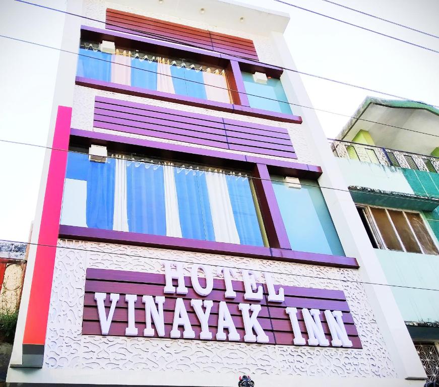 a building with a sign on the side of it at Hotel vinayak inn in Haridwār