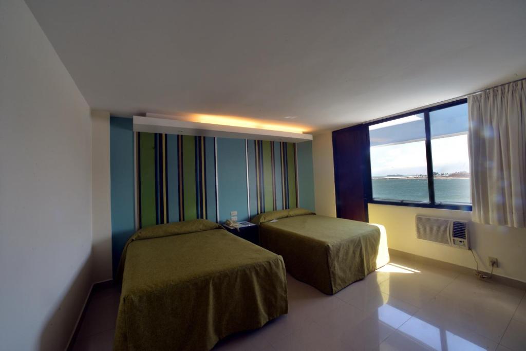 Postel nebo postele na pokoji v ubytování Hotel Mar y Tierra