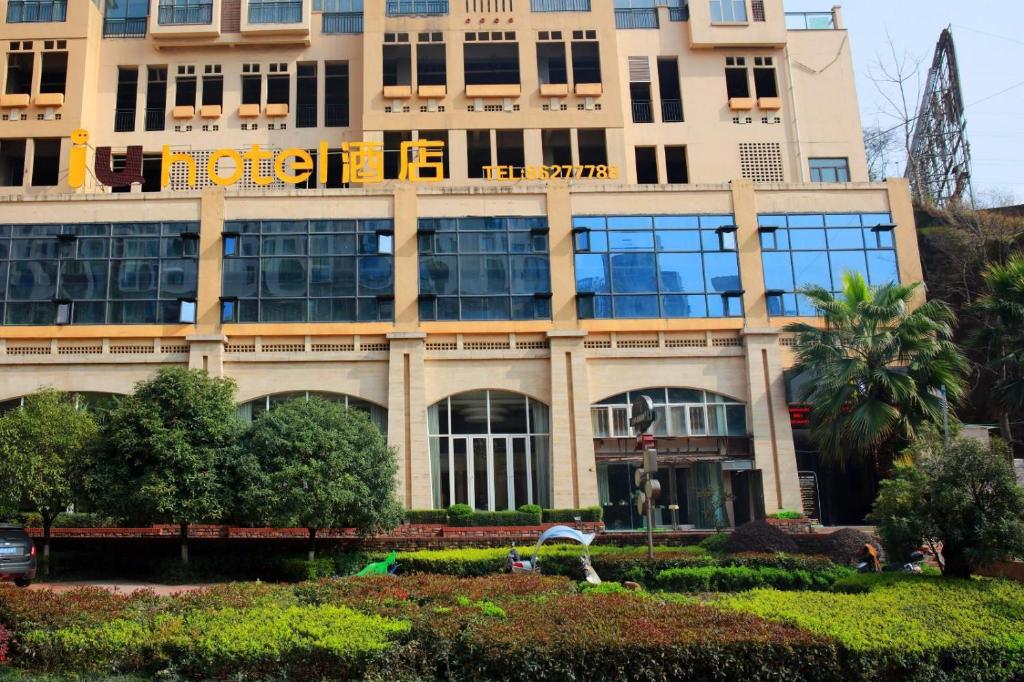a building with a sign on the side of it at IU Hotel Guiyang Future Ark Poly New City Guiyu Hot Spring Store in Guiyang