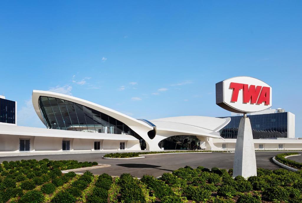 a large building with a tmi sign in front of it at TWA Hotel at JFK Airport in Queens
