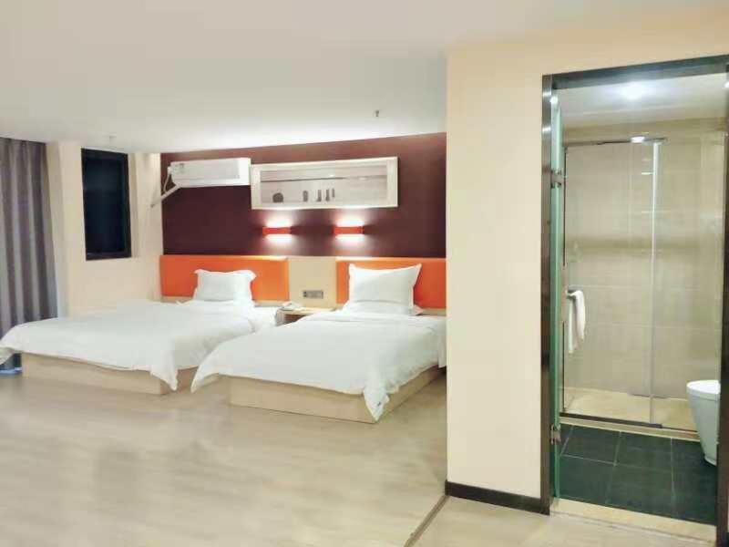 a hotel room with two beds and a shower at 7Days Premium Guiyang North Station in Guiyang