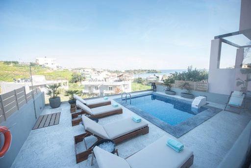 a house with a swimming pool and avisor at Emmeleia mare in Agia Pelagia