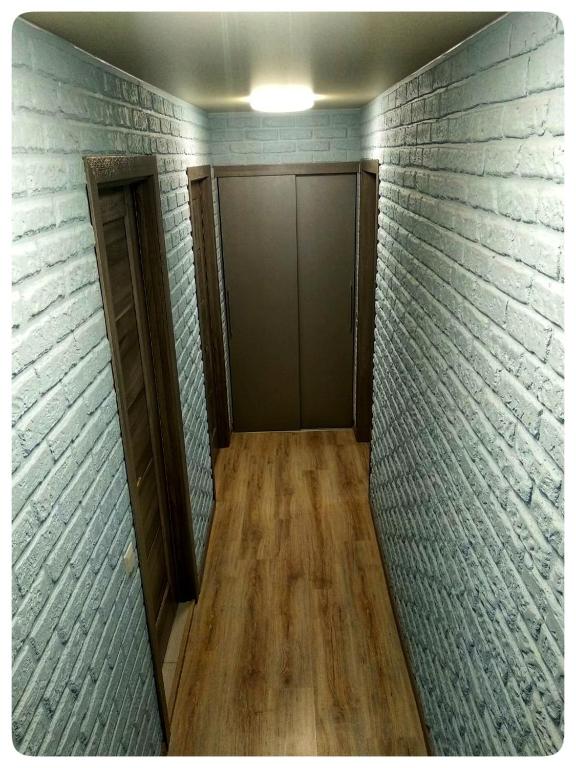 a hallway with a door in a brick wall at 2х кімнатна квартира на вулиці Лесі Українки in Uzyn