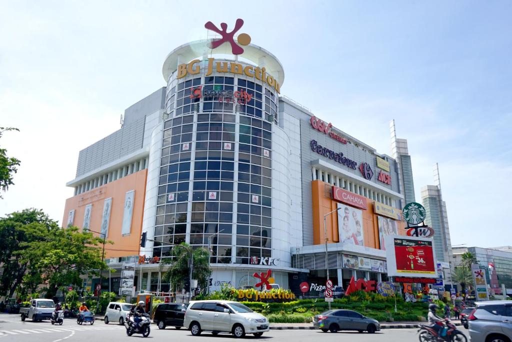 a large building with a sign on top of it at Choice City Hotel in Surabaya