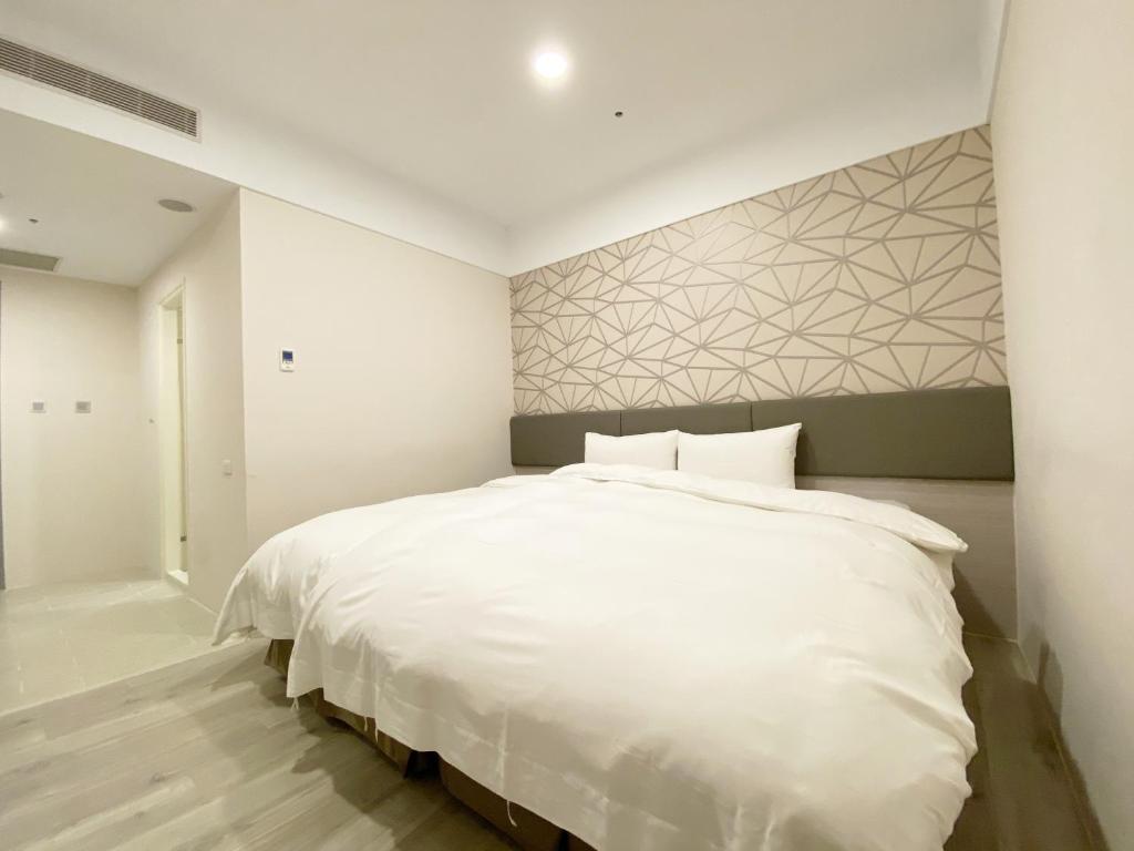 Postel nebo postele na pokoji v ubytování Fengjia JinRui Hotel