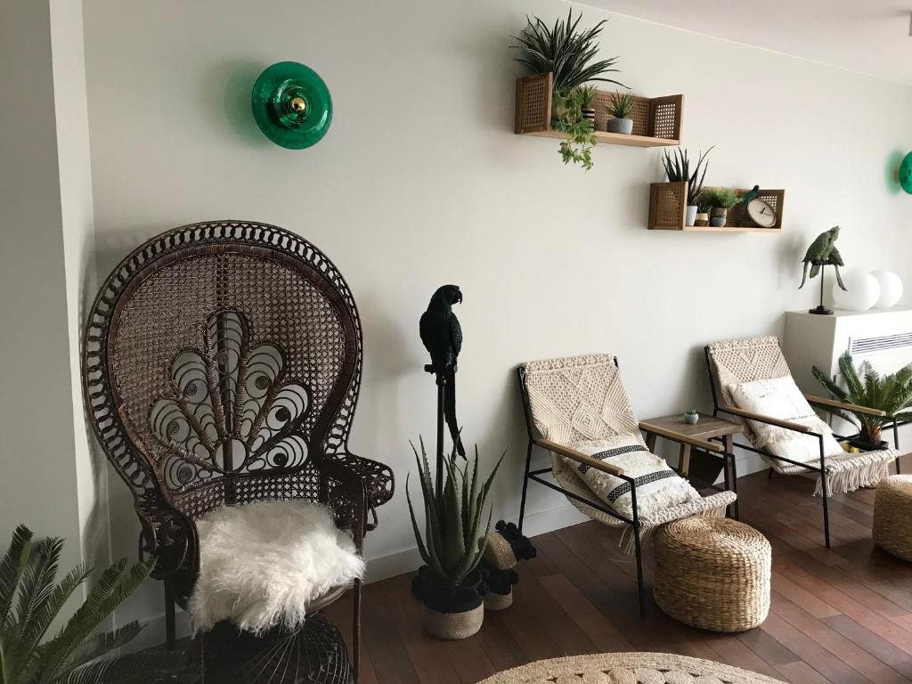 a bird sitting on a chair in a living room at Hôtel La Villa Port d'Antibes & Spa in Antibes