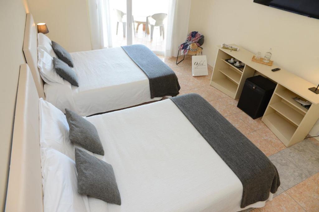 Postel nebo postele na pokoji v ubytování Rallye Hotel