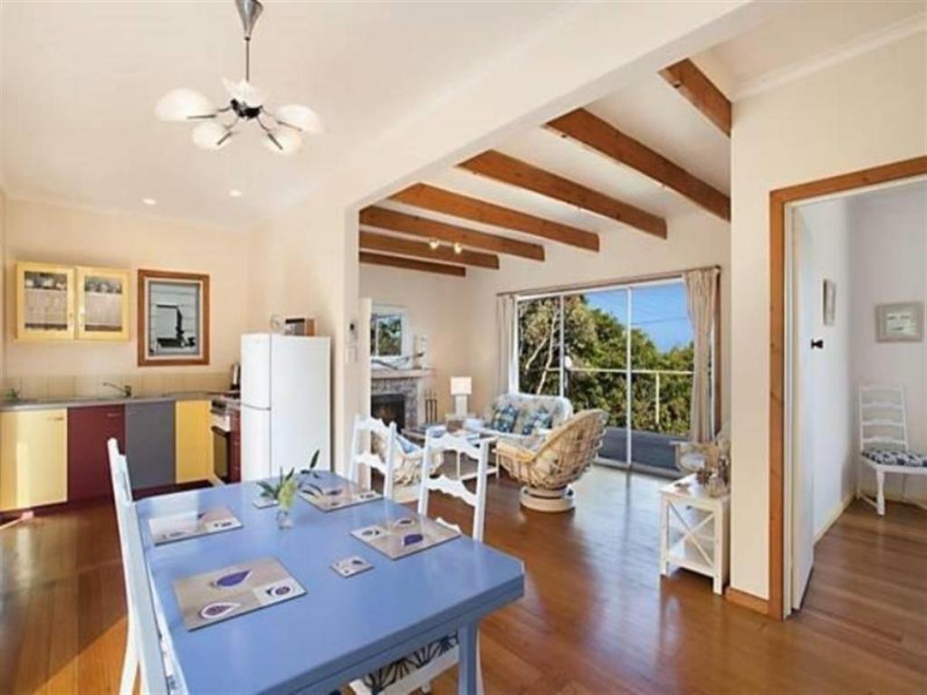 a kitchen and living room with a blue table in a room at Otway Blue in Wye River