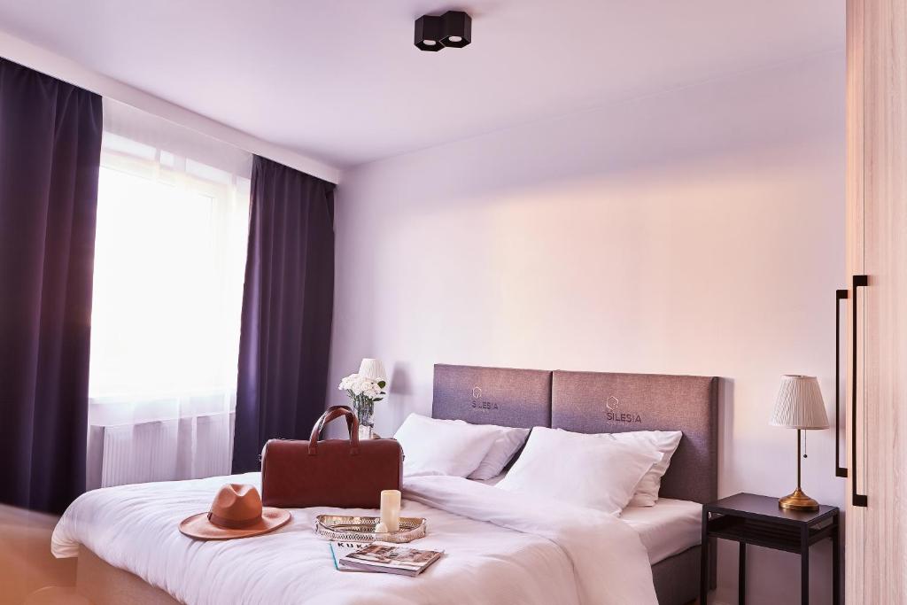 Posteľ alebo postele v izbe v ubytovaní Silesia Apartments