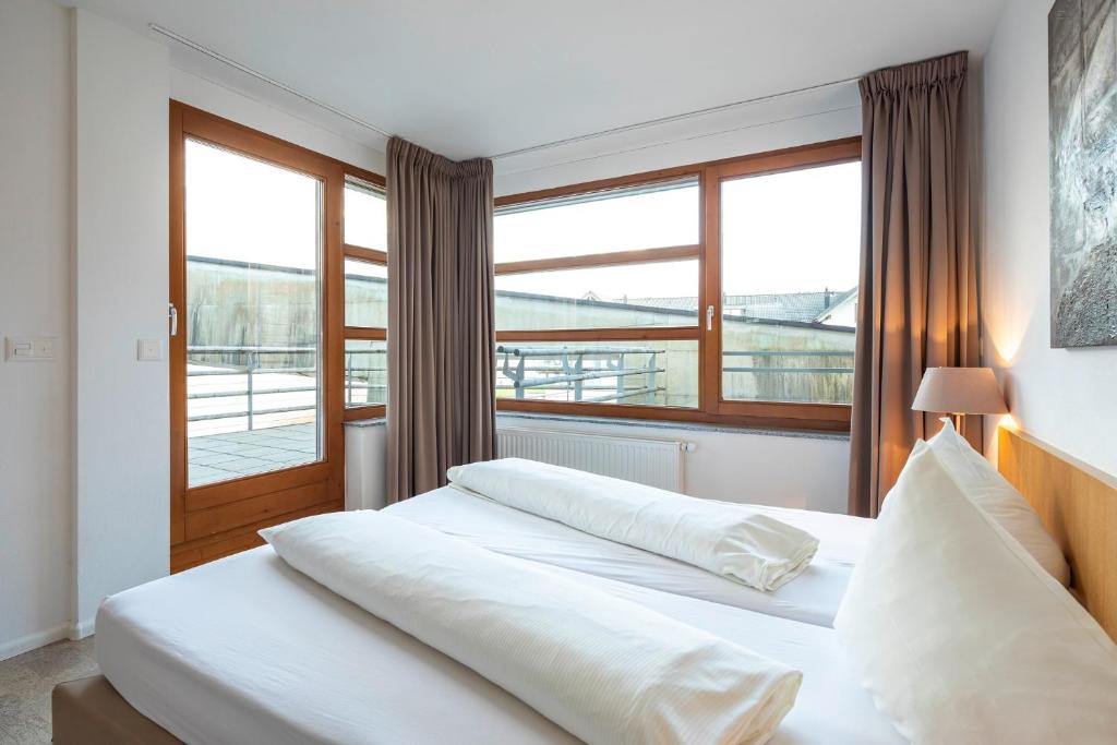 Postel nebo postele na pokoji v ubytování Marina Walensee Hotel