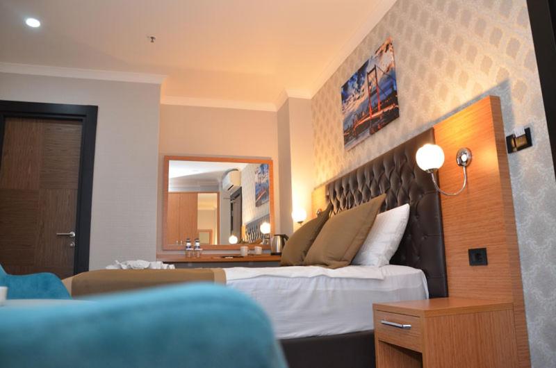 A bed or beds in a room at Otel Grand Lark İstanbul