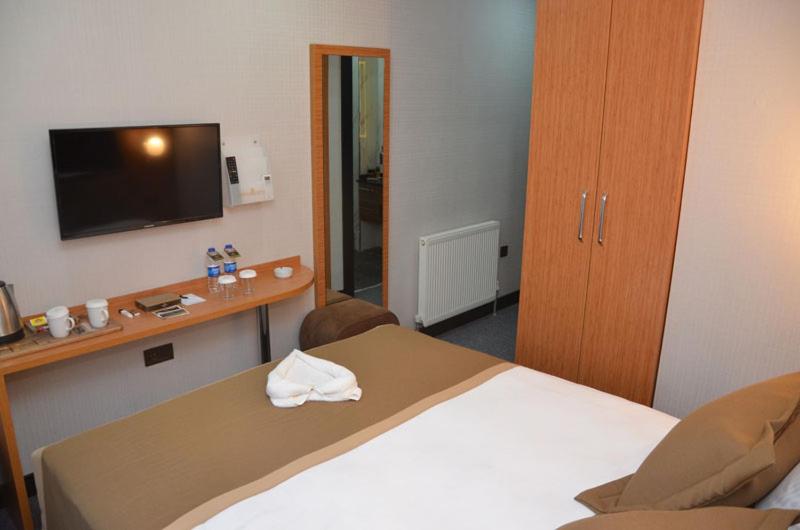 A bed or beds in a room at Otel Grand Lark İstanbul
