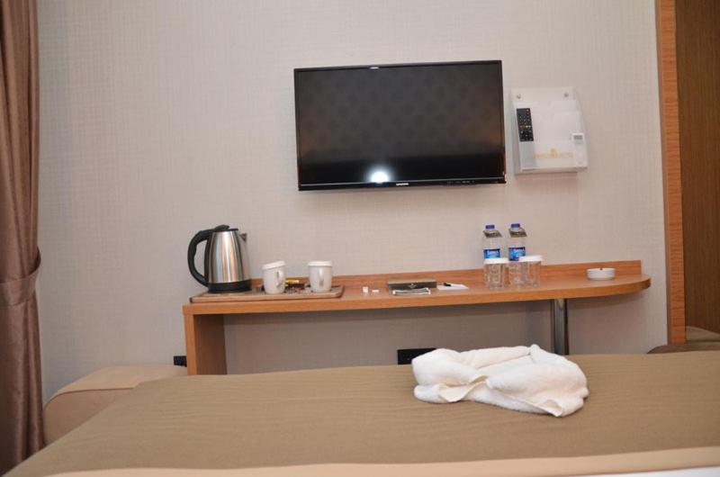 A bed or beds in a room at Otel Grand Lark İstanbul
